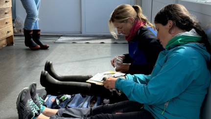 Kim and Katie processing Banded Dotterels in the control tower of the Chatham Island airport while Joe Breeze oversees