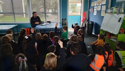 Tim with kids at school